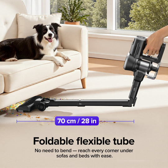 Foldable flexible tube of a vacuum cleaner with a dog on a couch in the background