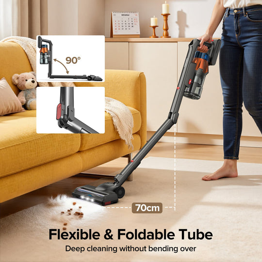 Person using a vacuum cleaner in a living room with a focus on its flexible and foldable tube feature.