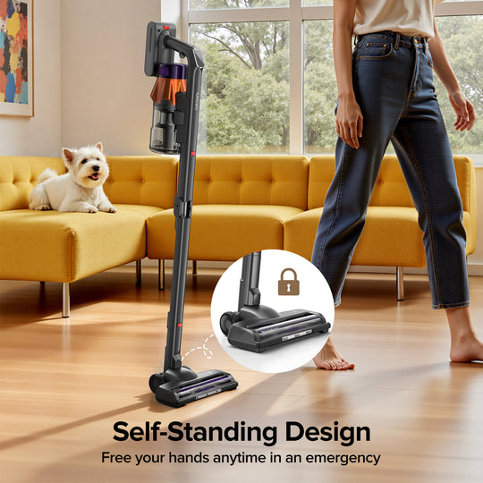 Person using a self-standing vacuum cleaner in a living room with a dog on a yellow couch.