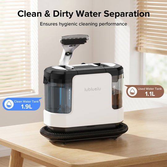 A desktop water separator and cleaner device by lubluelu sits on a light wood table in a bright room with window blinds. The product has a white body with black top and base components, and transparent tanks.